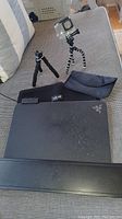 GoPro mounted on flexible tripod, small metal tripod, VAIO carrying case, Razer Firefly laptop visible on couch