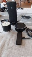 WSTER WS-K66 speaker, Amazon Echo Dot, Amazon Firestick with cables on table