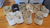 Group photo of 11 assorted golf hats with US Open and related logos