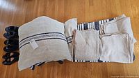 Linen pillow, pillowcases, and rug with navy stripes on wooden floor