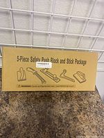 Box of 5-piece safety push block and stick package with illustration of included items