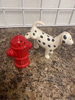 Photo of Dalmatian dog and fire hydrant salt and pepper shakers on countertop, showing shape and paint details