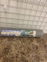 Roll of Garden Zone galvanized hardware cloth with labels showing 24in x 25ft and 1/2in mesh size.