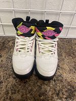 Front view of Jordan 60 Plus kids shoes size 6.5Y showing white leather upper, colorful tongue and laces.