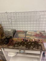 Overview of Lionel James Gang train set box with multiple track supports and accessories laid out on counter.