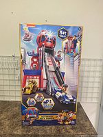 Front of box with image of Paw Patrol Ultimate City Tower 3 feet tall playset and included characters and vehicles