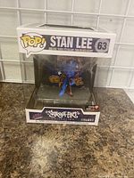 Front view of new, boxed Stan Lee Funko POP 63 figure with Street Art Collection Deluxe label.