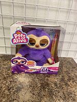 Front view of the Zuru Pets Alive Fifi The Flossing Sloth in original packaging showing the toy and box front details.