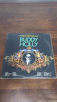 Front cover of Buddy Holly vinyl LP album 'A Rock & Roll Collection' showing ornate decorative graphics and photo of Buddy Holly.