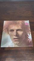 Front cover of David Bowie's Space Oddity vinyl album showing close-up face portrait of Bowie.