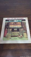 Front cover of The Doobie Brothers Best Of The Doobies vinyl record album showing jukebox artwork with coffee cups and title text.