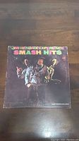 Front cover of the Jimi Hendrix Experience Smash Hits vinyl album with band photo and title.