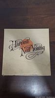 Front cover of Neil Young Harvest vinyl album with cream background and stylized text.