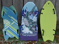 Front view of three foam sleds showing various colors and handle placements on each: green/blue Snow Slider, blue/purple Ice Predator with dragon art, lime green Snow Boogie