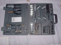 Top-down view of the open tool case showing pliers and some sockets and wrenches.