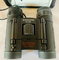 Top view of the Bushmaster 821BR binoculars showing branding and optical specifications on the body.