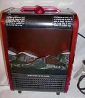 Photo of the heater showing its off state with simulated log front panel and safety warnings.