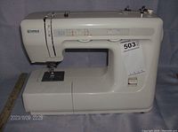 Side view of Kenmore sewing machine showing stitch selection panel, model label, and overall condition.