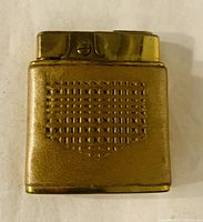 Front view of the gold and leather wrapped lighter showing textured leather pattern