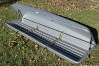 Side view with lid open showing interior and mounting rails supported by gas strut