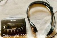 Sony Walkman WM-FX453 cassette player with wired headphones on white fabric background