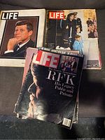 Three LIFE magazines displayed with JFK portrait, JFK with family, and RFK covers.