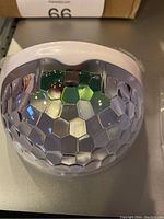 Close-up of one solar step light showing the semi-circular mosaic-patterned exterior cover.