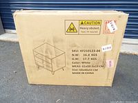 Cardboard box packaging showing product sketch and specifications including weight and size