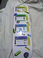 Full view of the medicine themed skateboard deck showing colorful pill capsules and medicine label prints on white background with light wear.