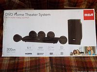 Photo of RCA DVD Home Theater System box showing system components and features.
