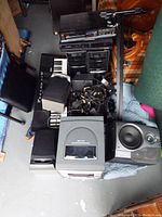 Overview of entire lot showing 3CD player, speakers, keyboard, cables and other audio components stacked