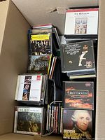 Top view of a box filled with classical music CDs including Beethoven, Mendelssohn, Haydn, Schubert, and others.