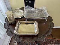 Photo showing all five silver plate items: lasagna pan with glass insert, serving tray, pickle plate, candle holder with etched glass shade