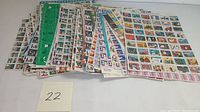 Two stacks of Easter Seals stamp sheets showing many colorful small stamps on sheets with various charity-related images, from a front and side angled view.