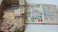 Box containing mixed confirmed US and foreign stamps, cancelled and uncancelled, some on envelopes