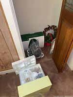 Photo showing the lot items including original boxes, church, wreaths, and other small decorations.