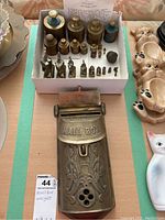 Overhead view showing all items: decorative brass mailbox and grouped weights in box