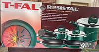 Box front showing T-Fal Resistol 9-piece cookware set in green with stainless steel lids and black non-stick interiors.