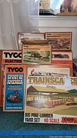 Photo showing boxed Tyco vintage train sets and Cox Trainscapes Big Pine Lumber Yard set