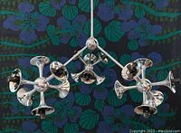 Front‐angle view of chrome Sputnik pendant light showing three starburst arm clusters