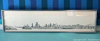 Full view of the rectangular framed black and white San Francisco Skyline print by Richard Sebring, slightly yellowed with some stains.