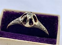 Ring displayed in a purple velvet-lined box