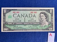 Front view of a 1967 Canadian one dollar bill featuring the centennial symbol, Queen Elizabeth II portrait, and bilingual text.