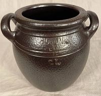 Front view of brown salt glazed pottery jar with embossed brand and capacity markings