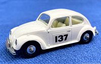 Left side view of white Volkswagen 1500 Saloon diecast car with racing number 137 on door, showcasing vehicle body, wheels and interior detail.