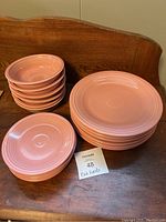 Photo showing the full set of 18 pieces with 6 dinner plates, 6 bowls, and 6 salad plates stacked separately on a wooden surface.
