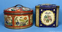 Both vintage Dunn Scottish biscuit tins displayed side by side, showing overall size and decorative details