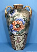 Full view of the vase showing the hand painted large flowers and two handles.