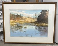 Framed watercolor painting displayed against a wall.