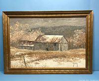Framed oil painting showing entire artwork and frame with rustic barns and landscape.